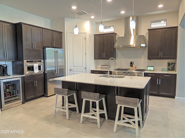 21696 E Arroyo Verde Dr, Queen Creek, AZ 85142 - kitchen with visible vents, wall chimney exhaust hood, wine cooler, stainless steel appliances, and a sink