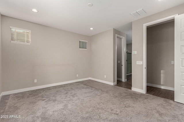 unfurnished bedroom with dark carpet