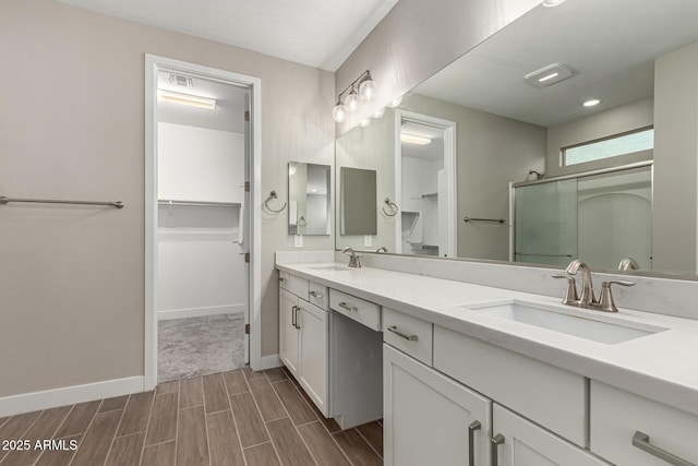 bathroom with walk in shower and vanity