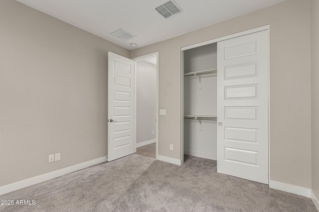 unfurnished bedroom featuring a closet and light carpet