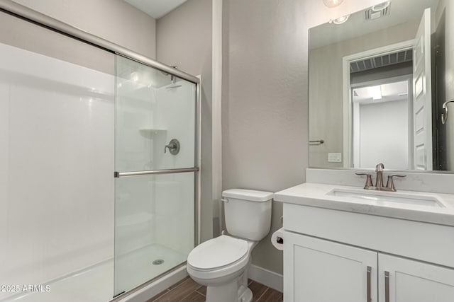 bathroom with walk in shower, vanity, and toilet