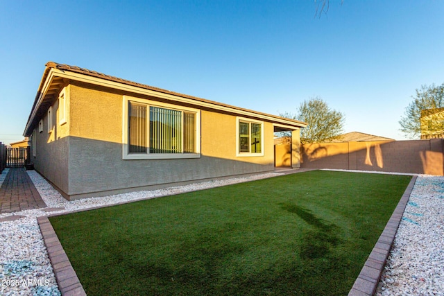 back of house with a lawn