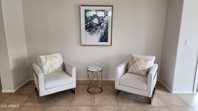 living area with tile patterned floors and baseboards