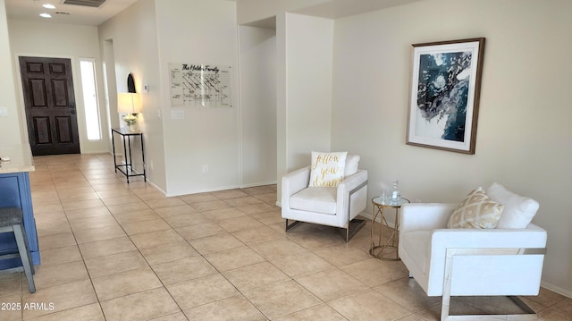 living area with light tile patterned floors, visible vents, baseboards, and recessed lighting