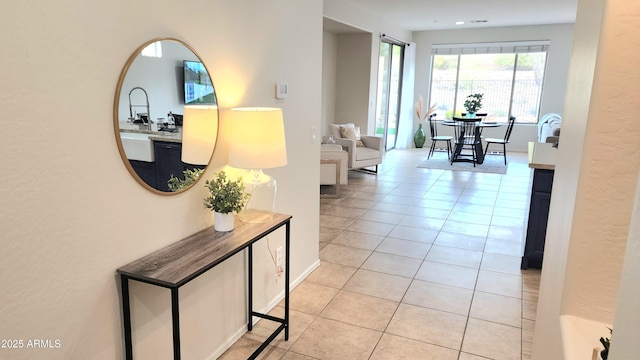 hall featuring light tile patterned floors