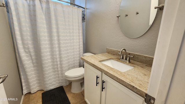 full bath featuring vanity, a shower with shower curtain, tile patterned flooring, toilet, and a textured wall