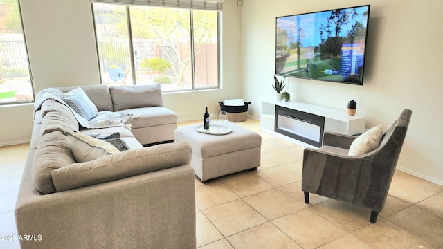 living room featuring light tile patterned floors and baseboards