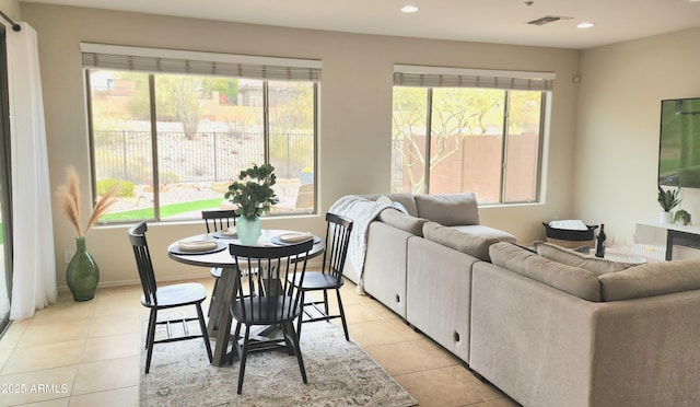 living area featuring light tile patterned flooring, recessed lighting, and baseboards