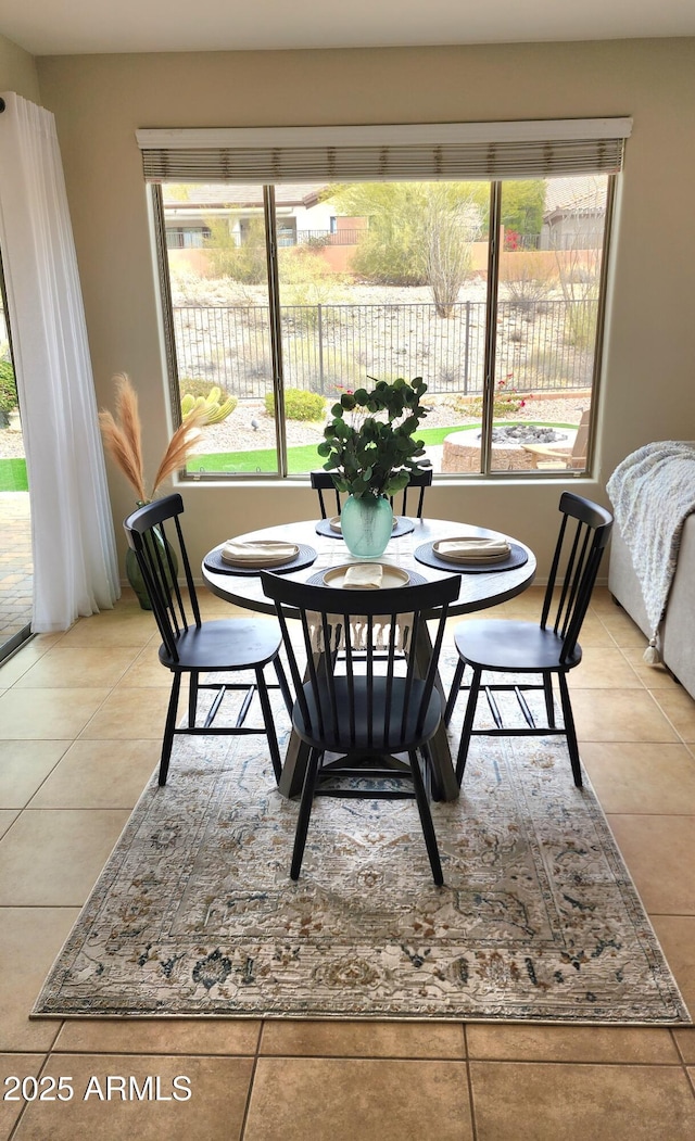 dining area with light tile patterned floors and plenty of natural light