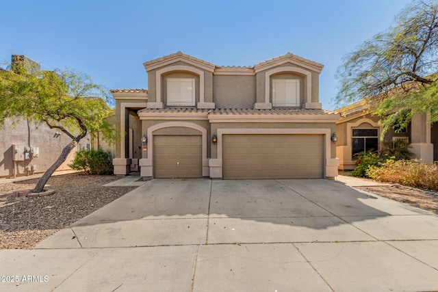 mediterranean / spanish-style house with a garage