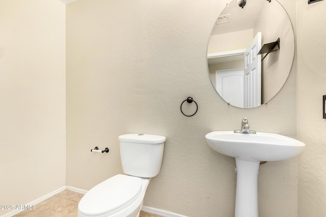 bathroom with tile patterned flooring and toilet