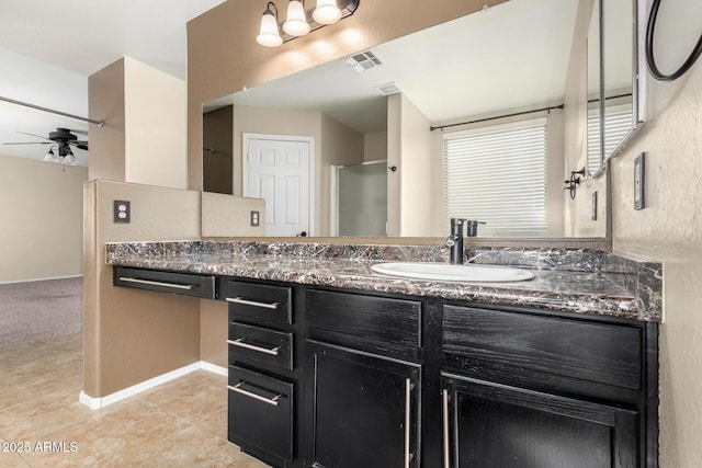 bathroom with tile patterned floors, vanity, a shower with shower door, and ceiling fan