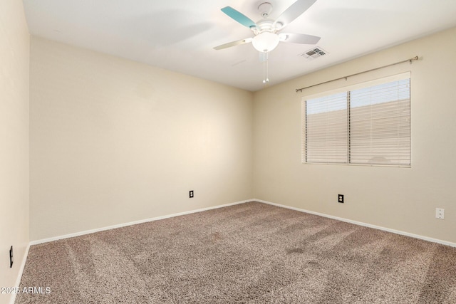 empty room featuring carpet floors and ceiling fan