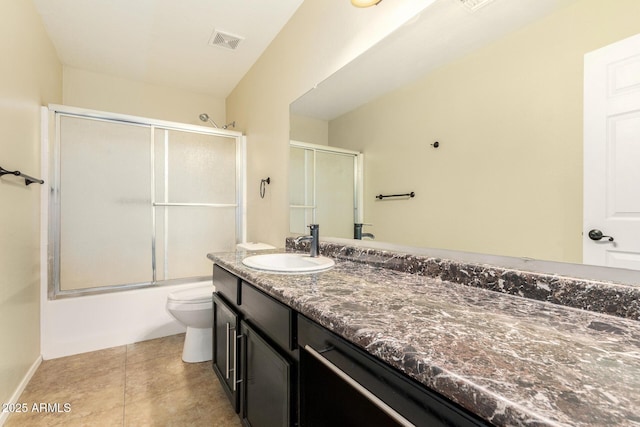 full bathroom with vanity, combined bath / shower with glass door, toilet, and tile patterned flooring