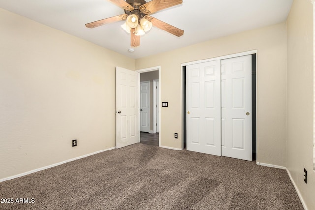 unfurnished bedroom featuring a closet, dark colored carpet, and ceiling fan