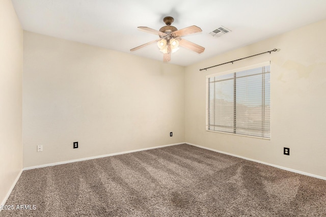 carpeted spare room featuring ceiling fan