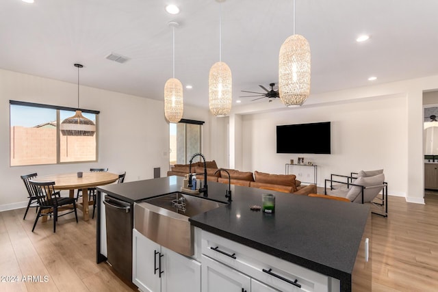 kitchen featuring white cabinetry, ceiling fan, hanging light fixtures, light hardwood / wood-style flooring, and stainless steel dishwasher