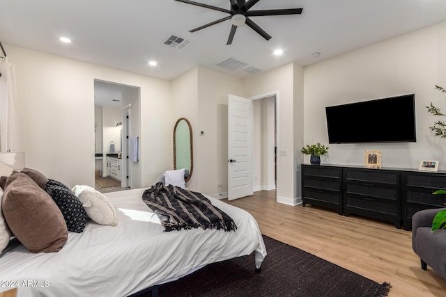 bedroom with ceiling fan, light wood-type flooring, and connected bathroom