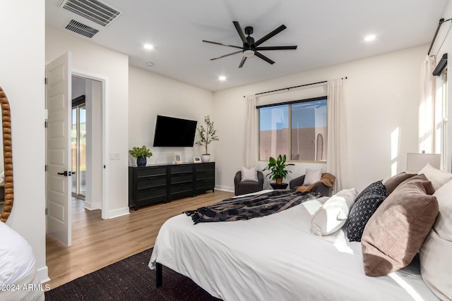 bedroom with light wood-type flooring and ceiling fan