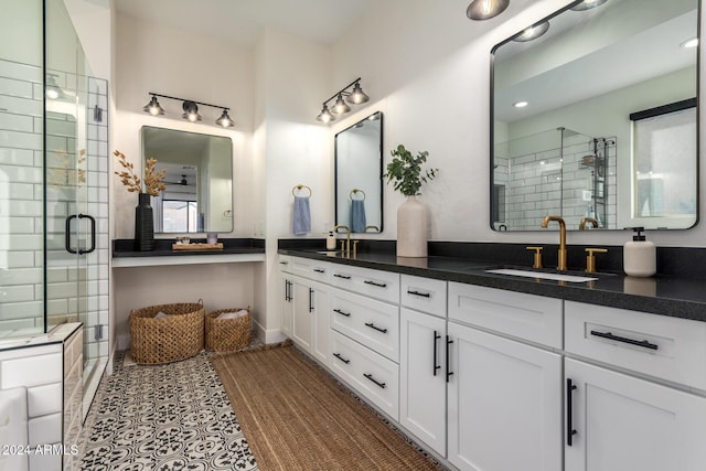 bathroom with vanity and a shower with door