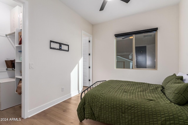 bedroom with light hardwood / wood-style flooring and ceiling fan