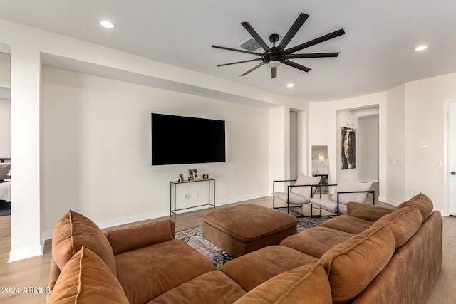 living room with light hardwood / wood-style floors and ceiling fan