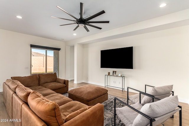 living room featuring ceiling fan and light hardwood / wood-style flooring