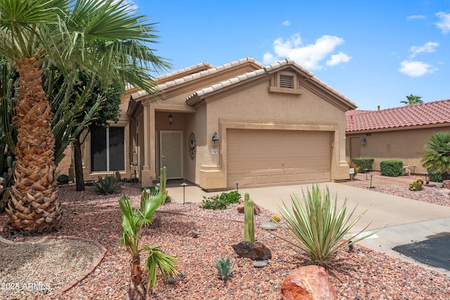 11553 W Cottontail Ct, Surprise, AZ 85378 - view of front of house with stucco siding, a garage, driveway, and a tiled roof