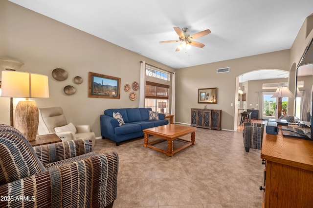 11553 W Cottontail Ct, Surprise, AZ 85378 - living area with a ceiling fan, healthy amount of natural light, arched walkways, and baseboards