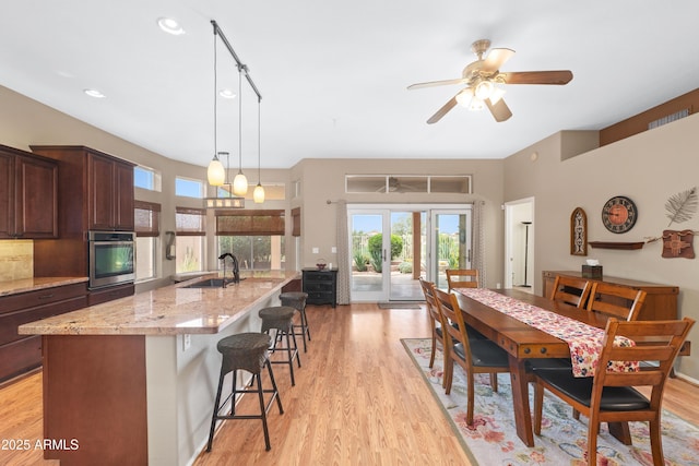 11553 W Cottontail Ct, Surprise, AZ 85378 - dining area with light wood finished floors, healthy amount of natural light, ceiling fan, and recessed lighting