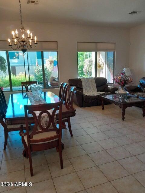 dining room with a notable chandelier and light tile patterned floors