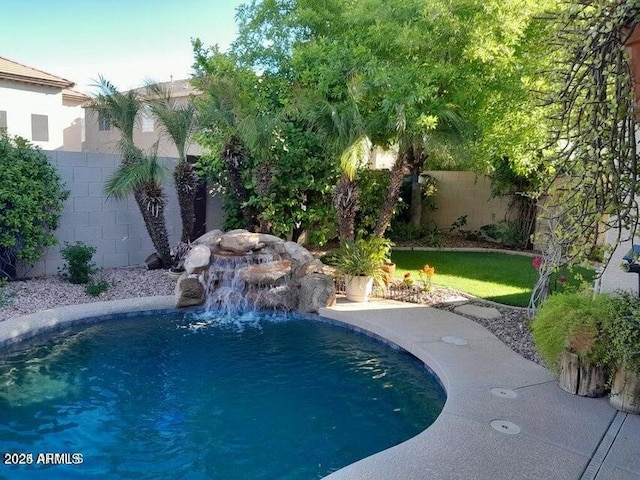 view of swimming pool with pool water feature