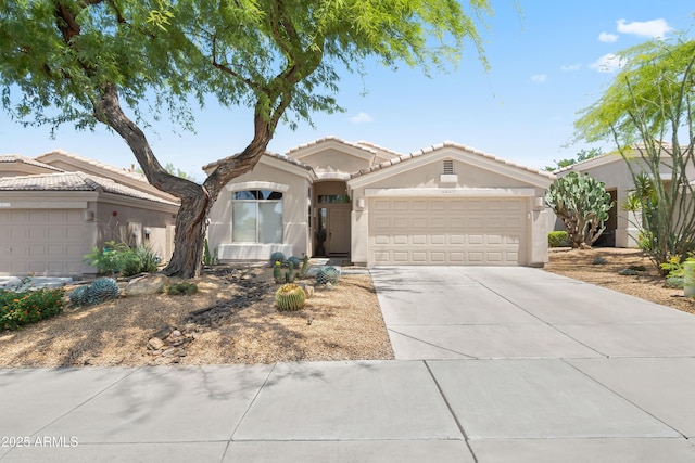 8848 E Conquistadores Dr, Scottsdale, AZ 85255 - single story home with stucco siding, an attached garage, driveway, and a tile roof