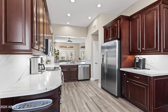 8848 E Conquistadores Dr, Scottsdale, AZ 85255 - kitchen featuring appliances with stainless steel finishes, recessed lighting, a ceiling fan, reddish brown cabinets, and light wood finished floors