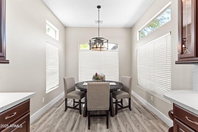 8848 E Conquistadores Dr, Scottsdale, AZ 85255 - dining space with a chandelier, light wood-style floors, and plenty of natural light