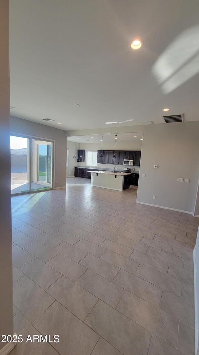 unfurnished living room featuring light tile patterned floors