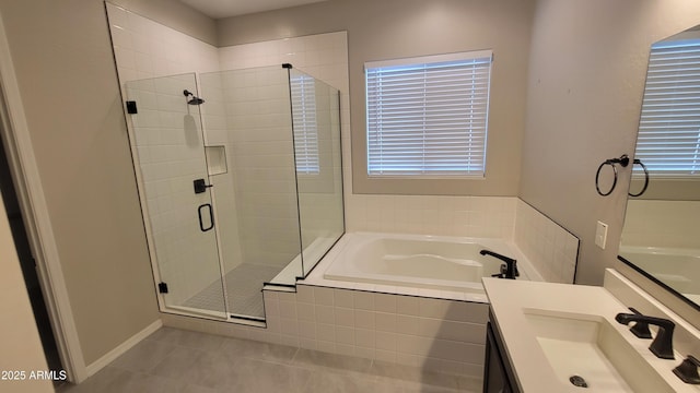 bathroom featuring shower with separate bathtub, vanity, and tile patterned floors