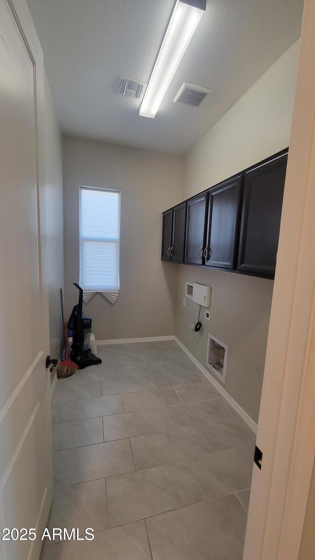 clothes washing area with hookup for a gas dryer, hookup for a washing machine, light tile patterned flooring, and cabinets