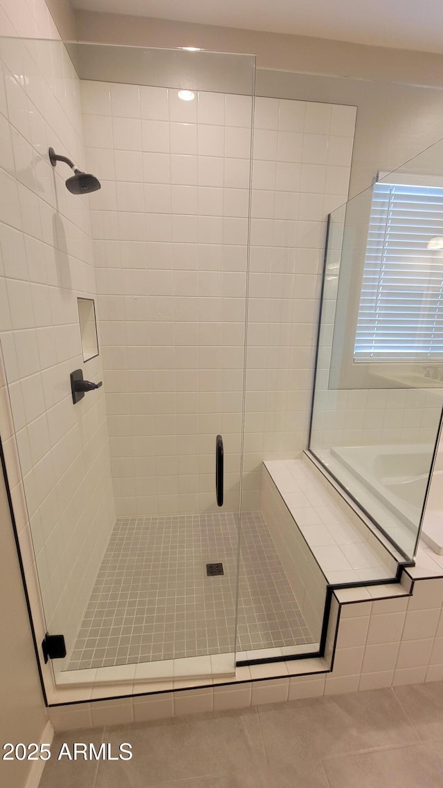 bathroom with tile patterned floors and a shower with shower door