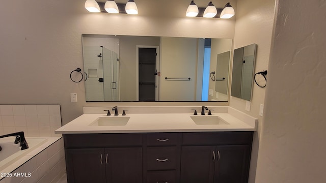 bathroom featuring vanity and shower with separate bathtub