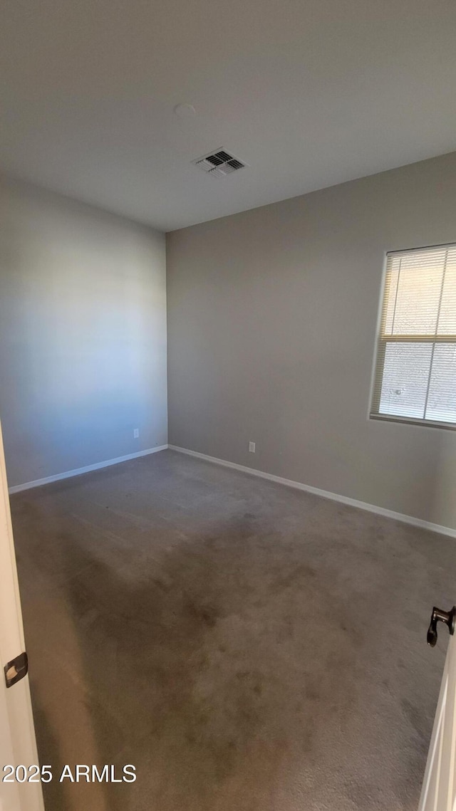 unfurnished room featuring carpet