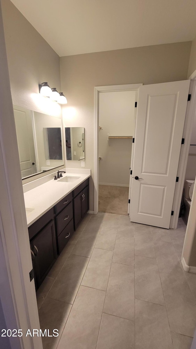 bathroom with tile patterned floors, vanity, and toilet