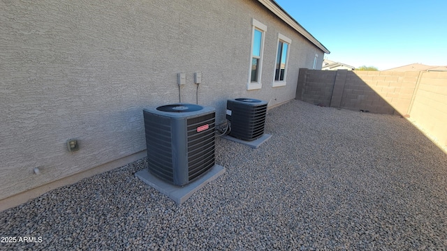 view of side of home with central AC unit