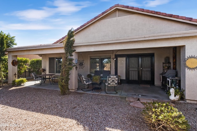 back of house with french doors and a patio area