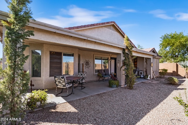 back of property featuring a patio