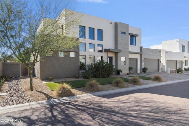 pueblo revival-style home featuring a garage