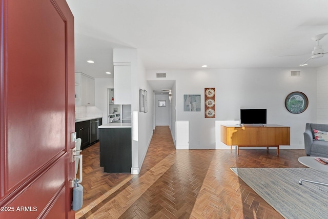 living room featuring dark parquet floors and ceiling fan