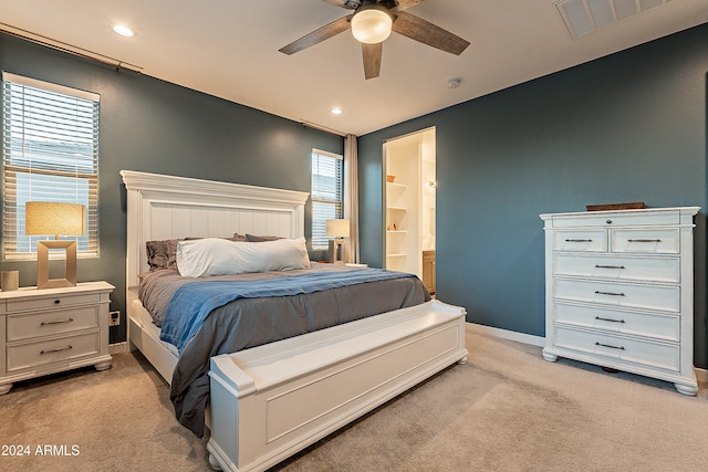 carpeted bedroom with ceiling fan and ensuite bathroom