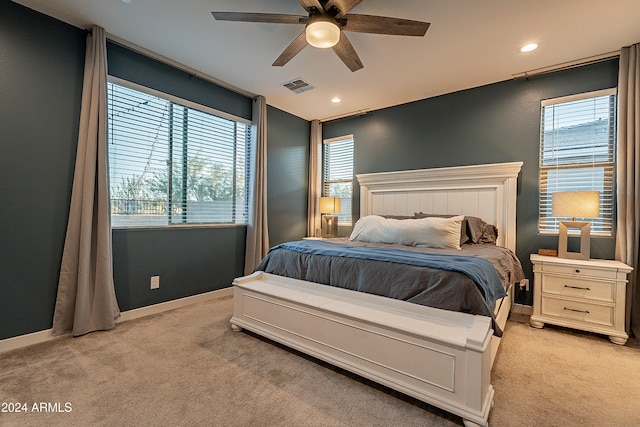 bedroom featuring light carpet and ceiling fan