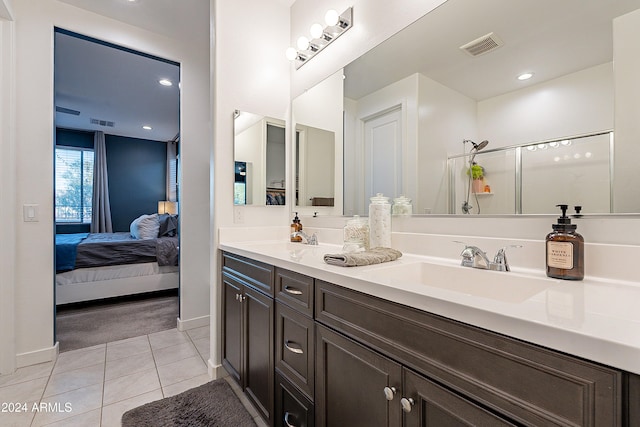 bathroom with vanity, tile patterned floors, and walk in shower